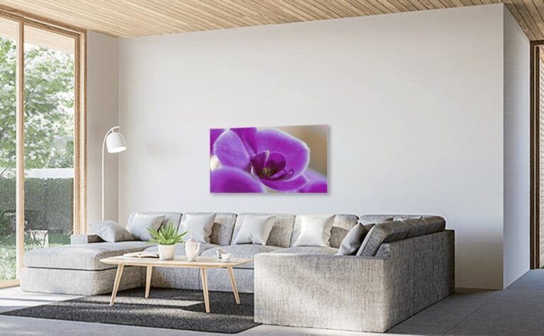 Bild-Infrarotheizung im Wohnzimmer mit einem Motiv von Orchideen, über der Couch an der Wand montiert